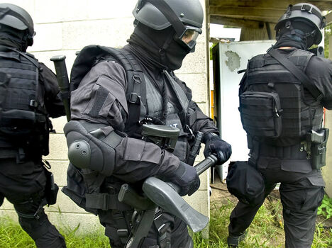 Police officers in tactical gear training Police officers in tactical gear training